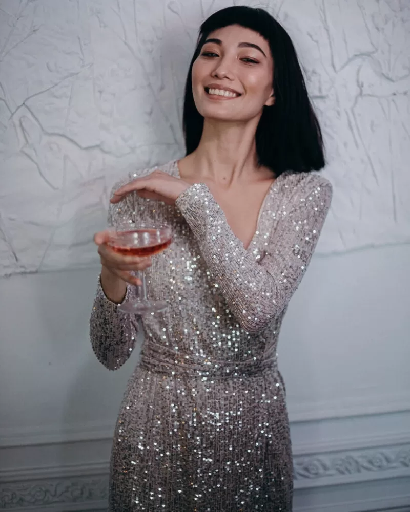 photo-of-woman-wearing-silver-dress-while-holding-cocktail-3402700-819x1024
